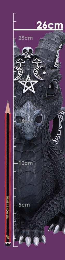 Black ornamental dragon figurine faces forward wearing skull and pentagram ornaments beside a vertical centimeter scale and a red-black pencil against a purple background. Text: 26cm, 25cm, 20cm, 15cm, 10cm, 5cm, NEMESIS NOW LTD, NN
