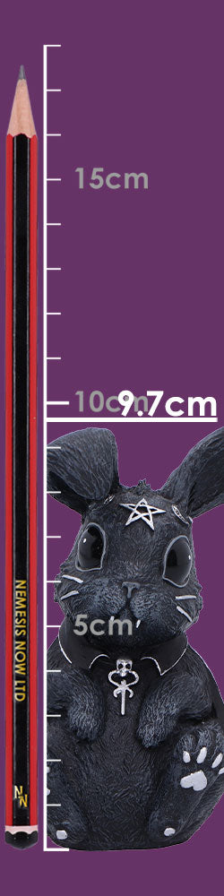 Black gothic rabbit figurine sits against a purple background beside a vertical ruler and pencil for scale; ruler markings read 15cm, 10, 9.7cm, 5cm and pencil text reads NEMESIS NOW LTD.