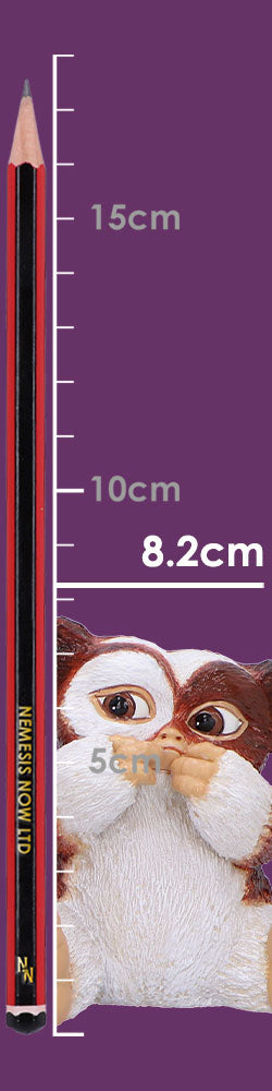 Pencil stands aligned to vertical measurement ticks while a small wide-eyed furry creature peeks from the right; purple background labeled 15cm 10cm 8.2cm 5cm NEMESIS NOW LTD