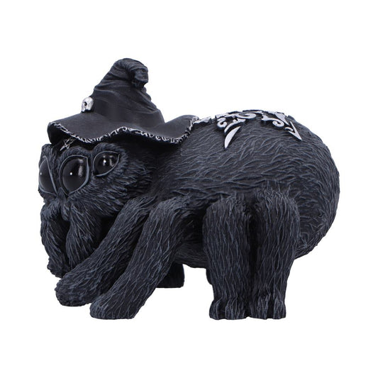 Black furry spider figurine wearing a crooked witch hat and silver filigree on its abdomen, crouching with oversized glossy eyes on a plain white background.