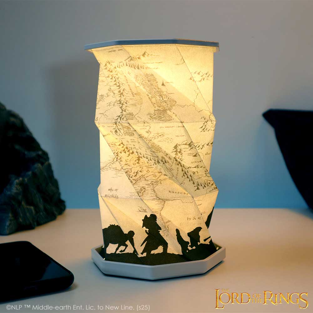 Lord of the Rings Middle-earth map lamp illuminated beside books