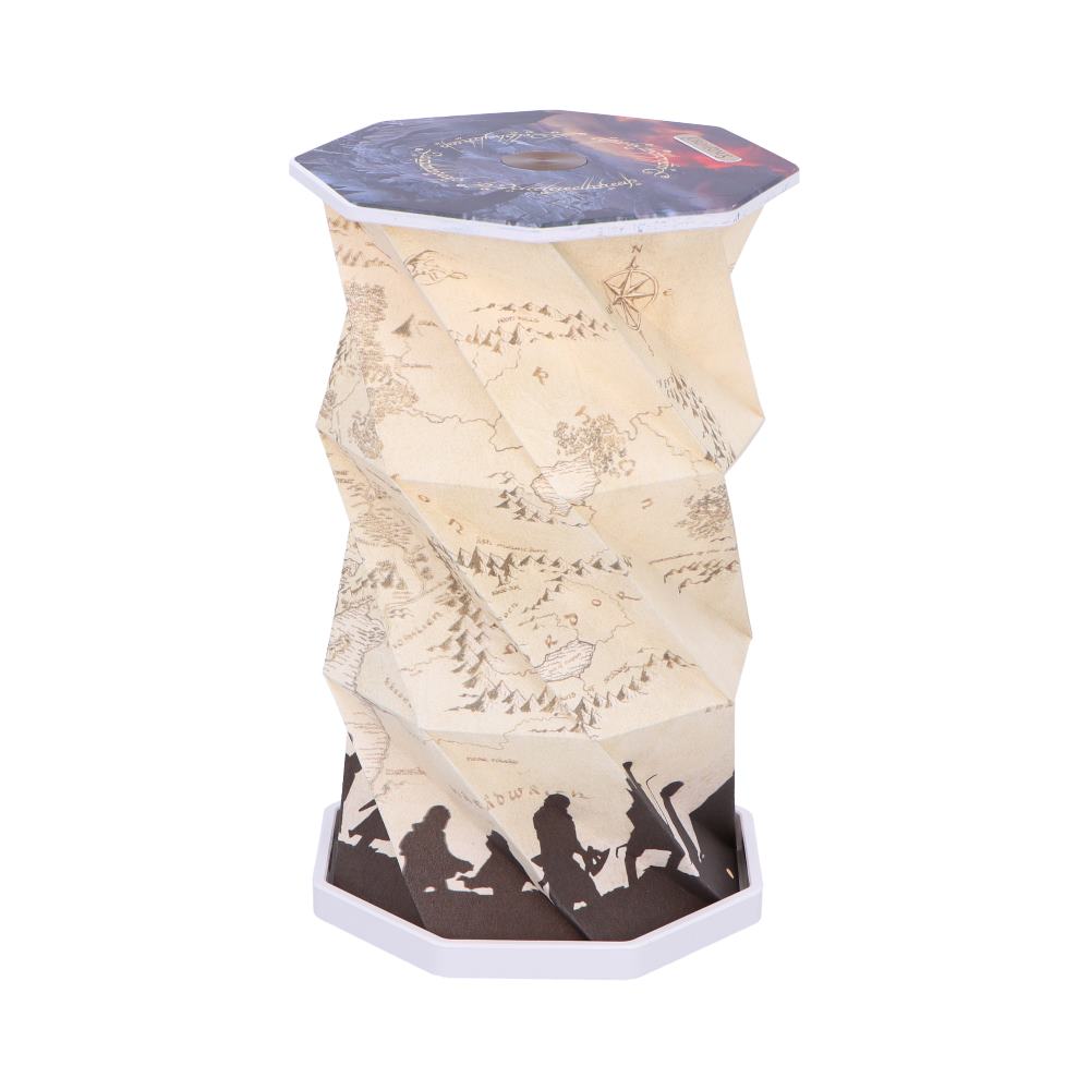 Octagonal paper lantern twists upward, displaying a vintage map print with silhouetted traveling figures at its base and a starry night map panel on top against a white background.