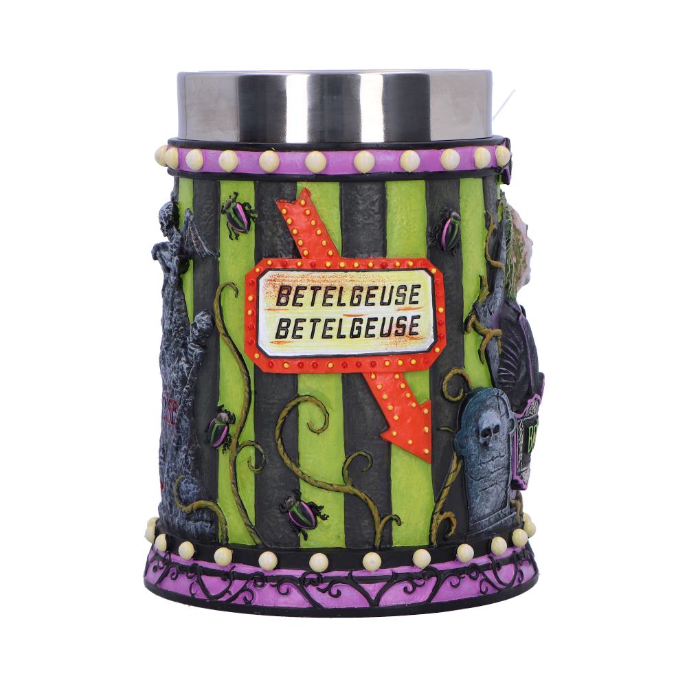Cylindrical decorative container features a lit marquee arrow sign reading BETELGEUSE BETELGEUSE, surrounded by green and black vertical stripes, sculpted skulls, vines, purple trim and a stainless steel rim.