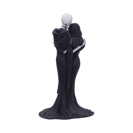 Sculpted skeletal couple embrace, male skeleton in cloak holding a long-haired female figure in a flowing black gown, standing on a small base against a plain white background. Text: ©N
