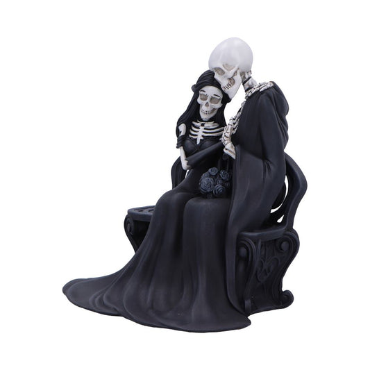 Skeletal couple sits on an ornate bench, one skeleton leaning its skull against the other's shoulder while the cloaked figures hold a bouquet of dark roses against a white background.