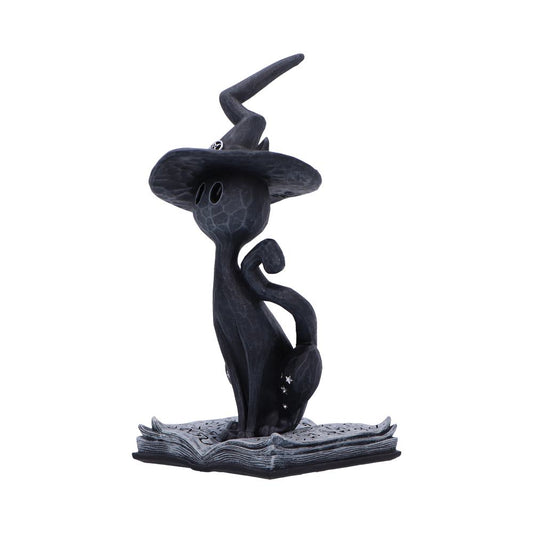 A stylized black cat figurine wearing a tall crooked witch hat sits atop an open spellbook, tail curled and blank oval eyes facing forward against a white background.