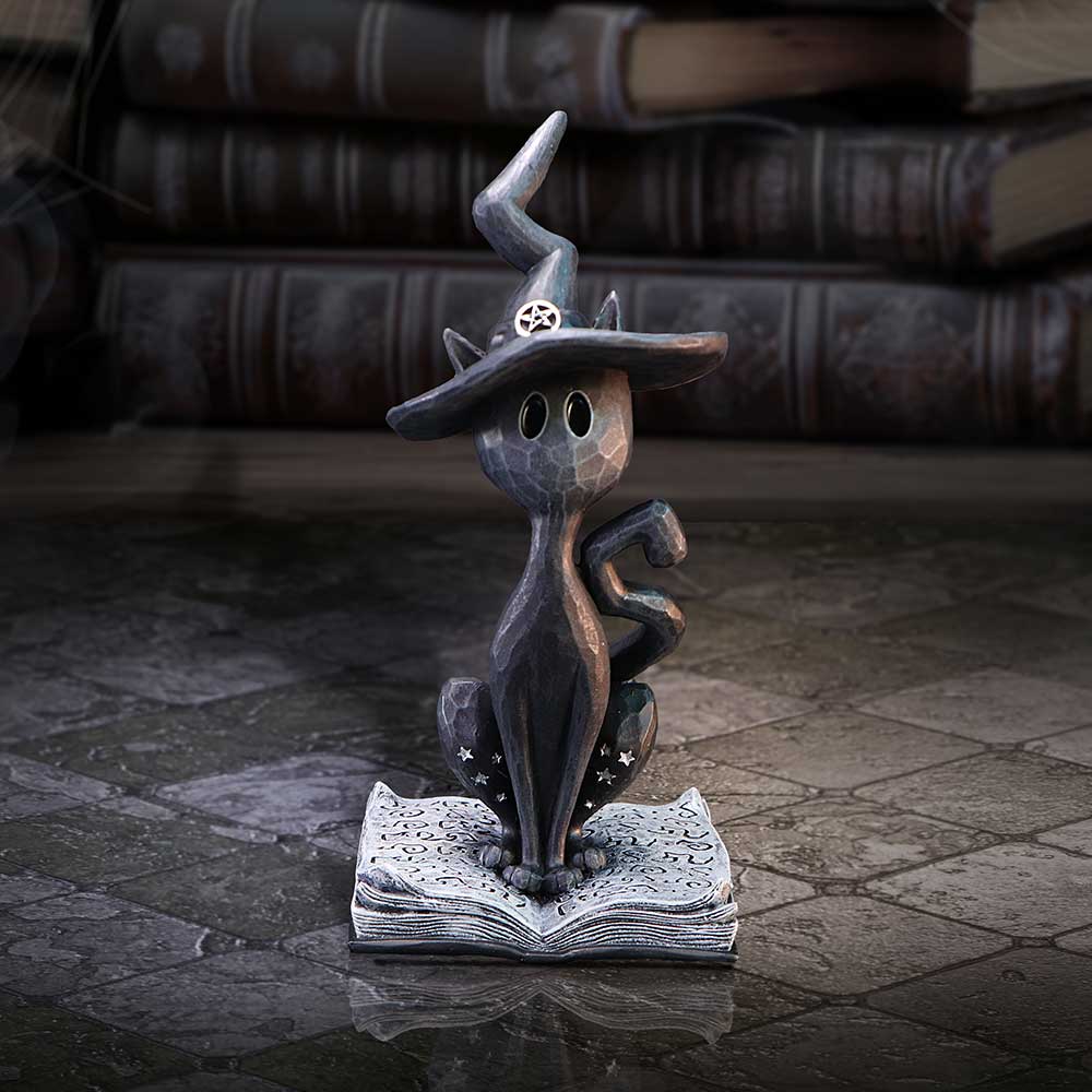 Conjure Spell Cat Figurine – black resin cat sitting on a spellbook wearing a witch’s hat