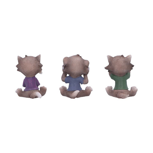 Three seated fox-like figurines on a white background perform see hear speak no evil gestures, each turned away and wearing purple, blue, and green shirts.