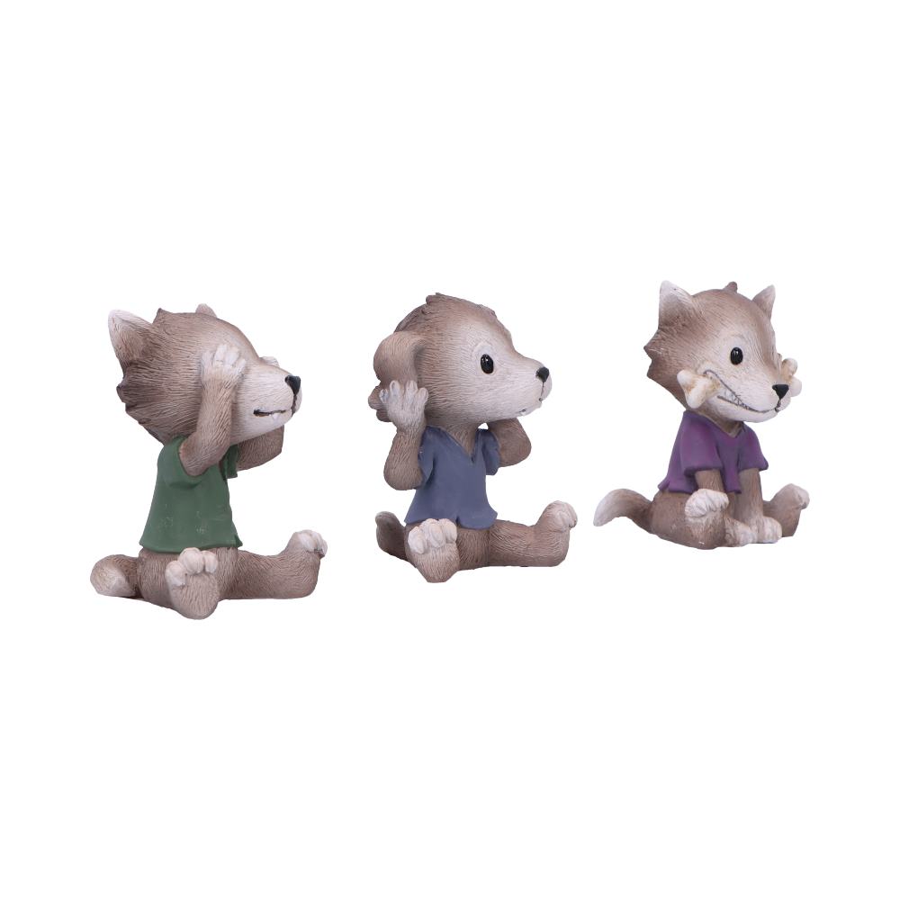 Three small wolf figurines sit in a row; left covers its eyes, center covers its ears, right covers its mouth, photographed against a plain white background.