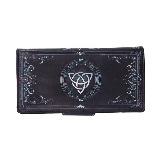 Wallet displays a silver triquetra emblem centered on a dark rectangular leather flap accented with decorative filigree, photographed on a white background.