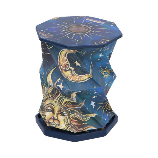 Octagonal collapsible stool folded into an hourglass shape, displaying gold sun and crescent moon motifs and scattered stars on deep blue fabric, photographed against a plain white background.
