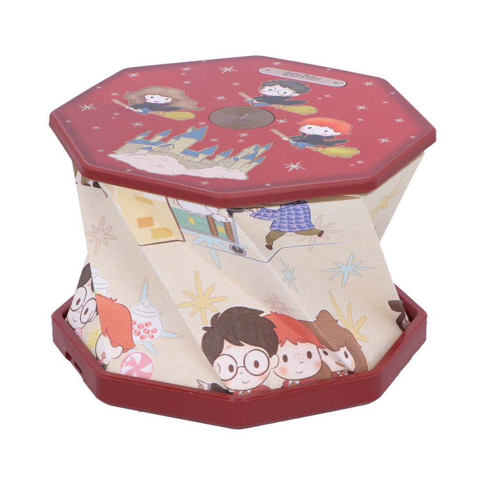 Octagonal red-topped music box featuring chibi Harry, Hermione and Ron flying and standing, pleated sides collapsing inward, Hogwarts illustration on sides; text "Harry Potter" on top; studio white background.