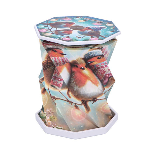 Octagonal collapsible decorative container displaying three robins wearing winter hats and scarves, perched on snowy branches with holiday lights, photographed upright against a white background.
