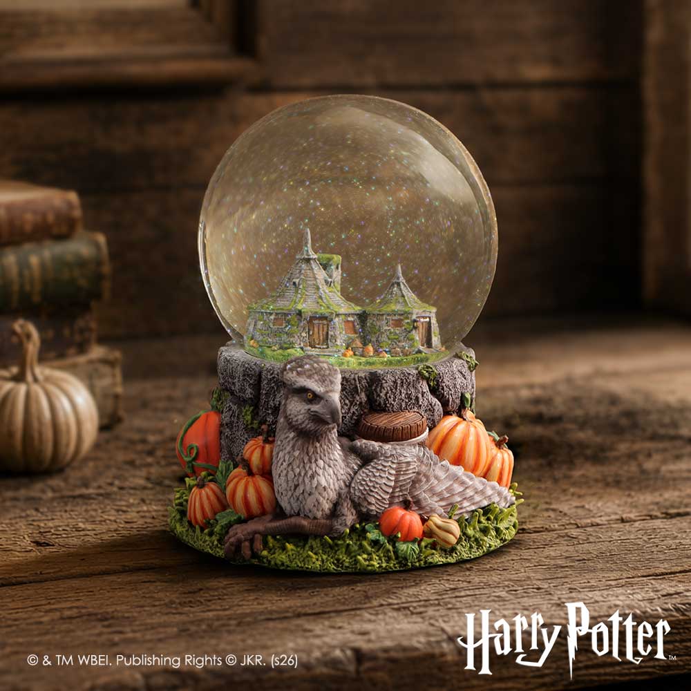 Harry Potter Hagrid’s Hut Snow Globe - snow globe displayed on a rustic wooden surface