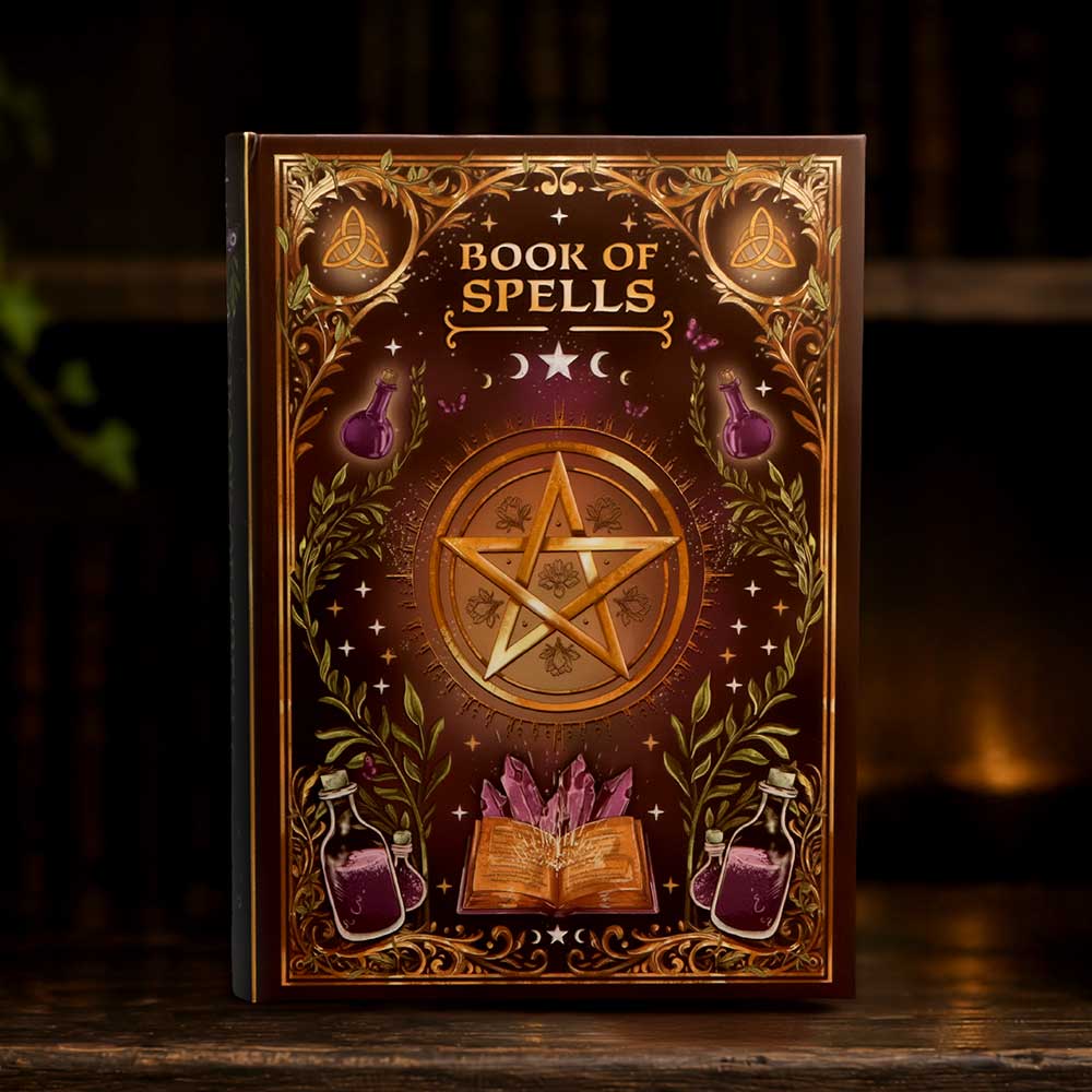 Book of Spells Journal - spell journal displayed beside candlelight