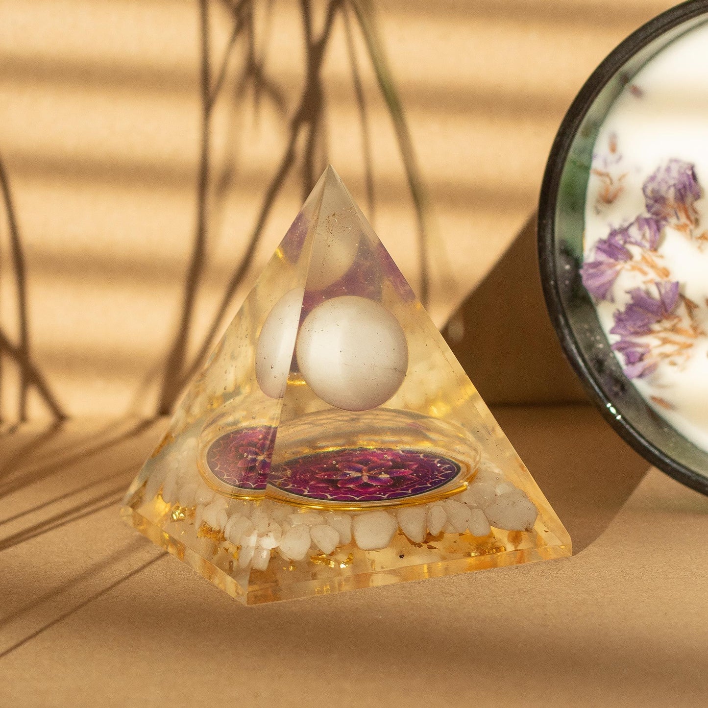 Medium orgonite pyramid with floating quartz sphere and natural quartz chunks in handcrafted resin, 7 × 6cm.