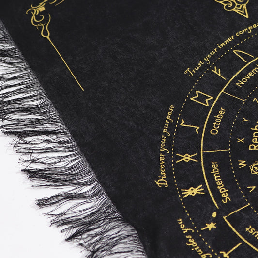 Ancient Witch Sun Face pendulum divination cloth in black and gold with detailed circular chart and decorative fringed cotton edges