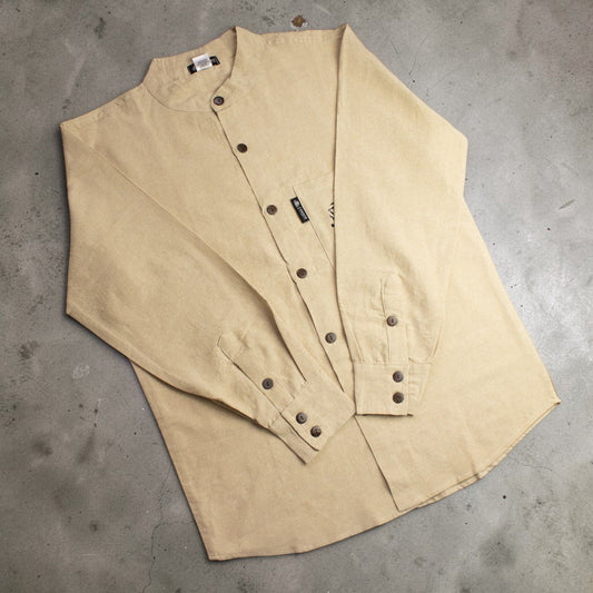 Medium stone Nomad Sari Kathmandu cotton shirt with long sleeves, collarless neckline and hand-painted chest pocket detail