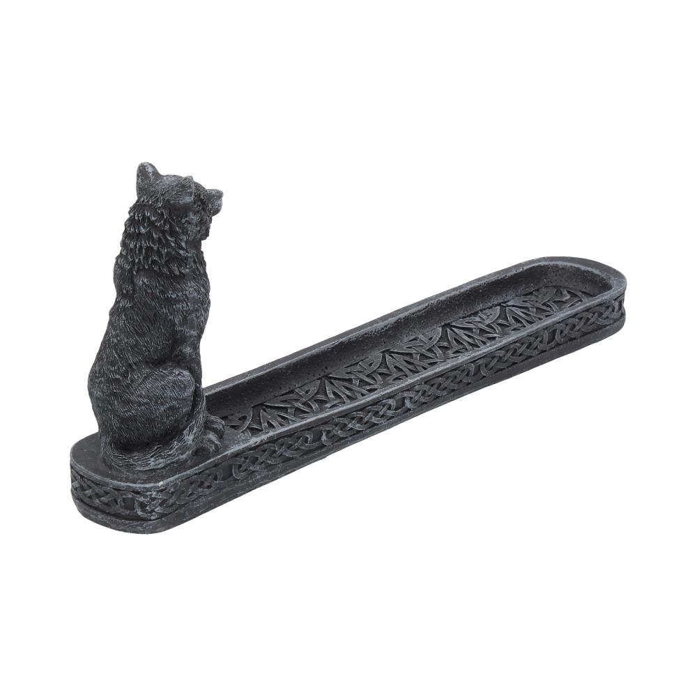 Wolf figurine sits facing forward atop a long shallow carved tray with Celtic knot patterns and dark stone finish on a white background.