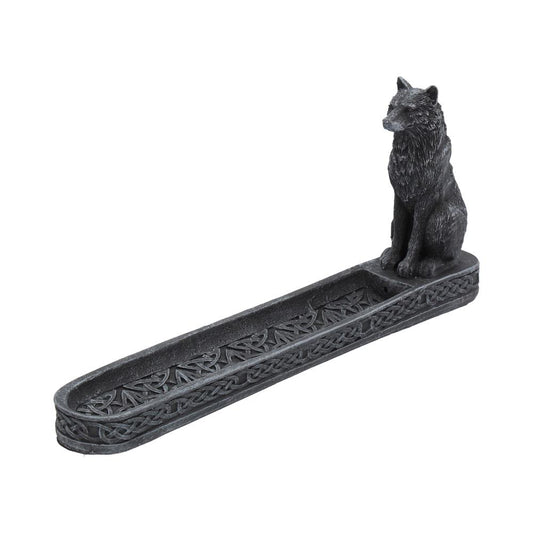Stone wolf figurine sits at one end of a long carved incense tray adorned with Celtic knotwork on a plain white background.