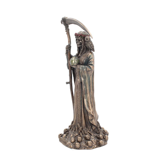 A bronze-colored reaper statue stands on a pile of skulls, holding a small green sphere and a scythe. The figure has a crown of red flowers and is draped in a robe.
