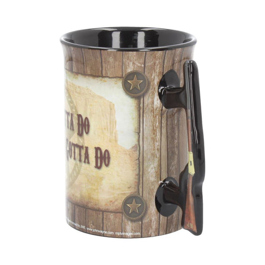 A cylindrical mug with a rifle-shaped handle, featuring a wooden texture design. The text reads "GOTTA DO WHAT A MAN'S GOTTA DO." Two star accents are visible on the mug.