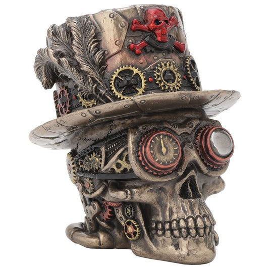 A steampunk-inspired skull sculpture, featuring gears and goggles, wearing a detailed top hat adorned with feathers and a red skull and crossbones, against a plain background.