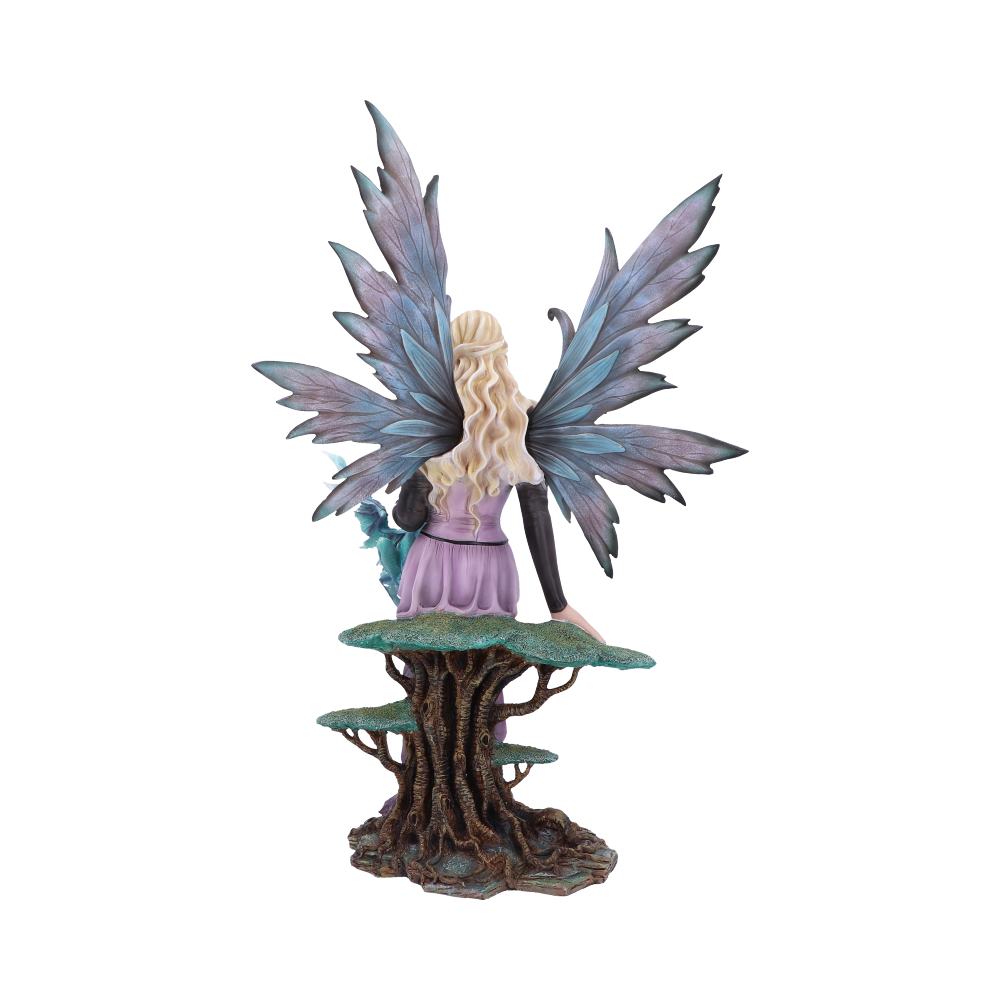 A fairy, viewed from behind, perches on a tree-like stump. The fairy has large blue and purple wings and is wearing a lavender dress and black sleeves.