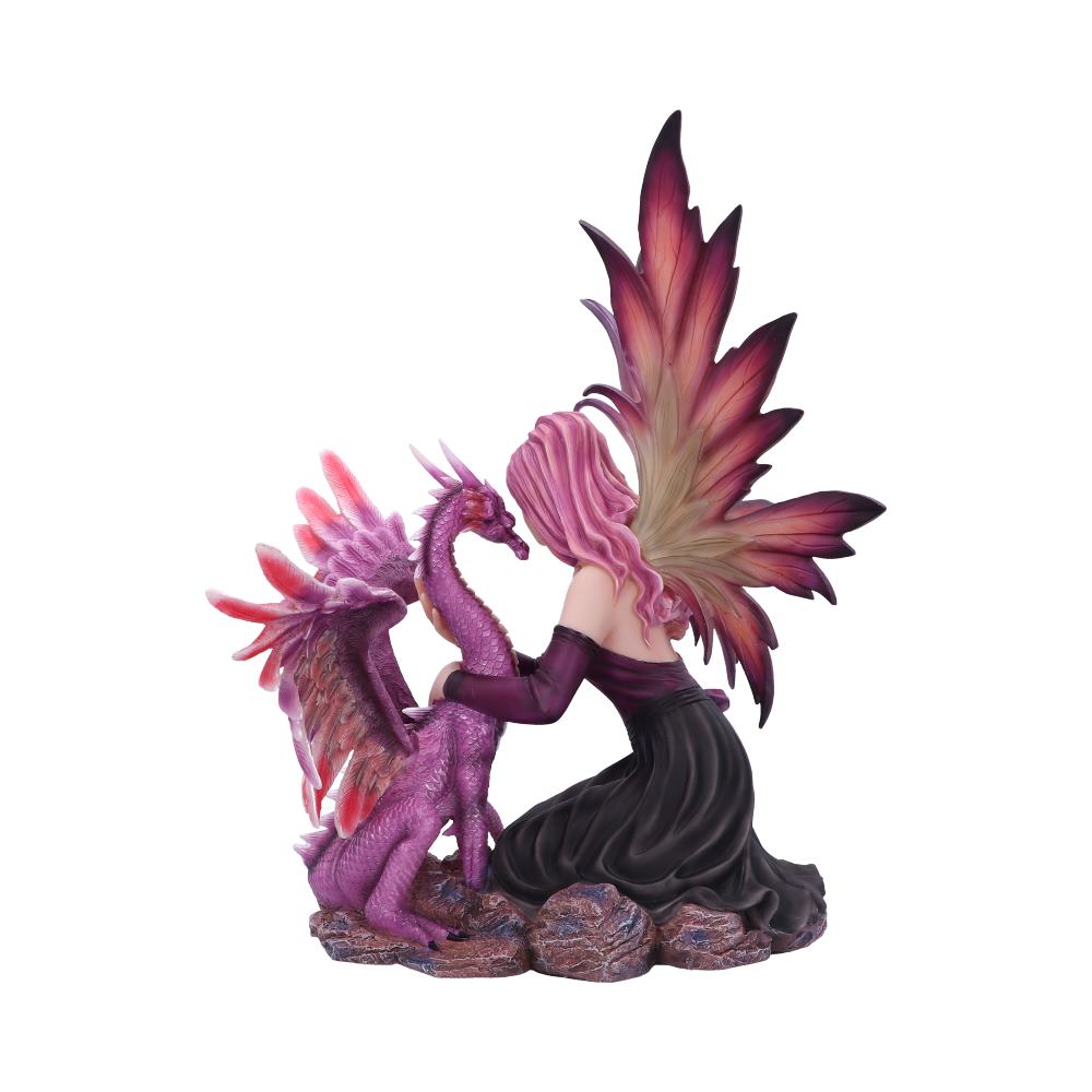 A fairy kneels, embracing a small, lavender dragon on a rocky base. The fairy has large, magenta wings and matching hair, while the dragon's wings are tinged with a similar color.