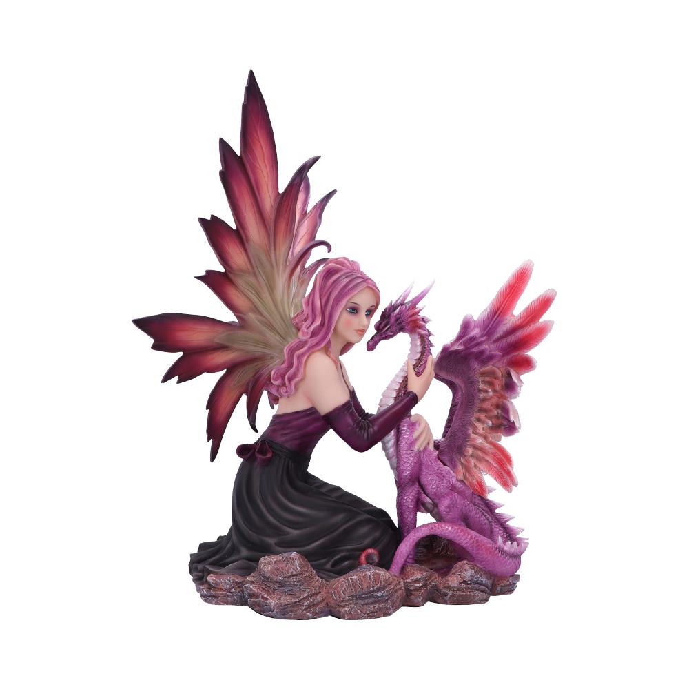 A winged fairy kneels on rocks, tenderly cradling the neck of a small, purple dragon with red-tipped wings.