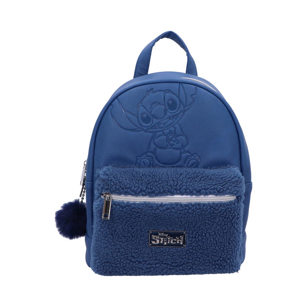 A blue Stitch backpack sits against a white background. The backpack features an embossed Stitch image and a sherpa-lined front pocket with a metallic "Stitch" label. A small fur pom-pom hangs from a zipper pull.