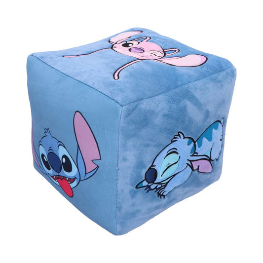 A blue plush cube features embroidered cartoon characters, including a playful blue creature with large ears and a pink character, set against a plain white background.