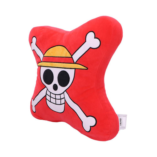 A red, star-shaped pillow features a cartoon skull wearing a yellow straw hat with crossbones behind it, resembling a pirate design. A small tag is attached to the pillow's edge.
