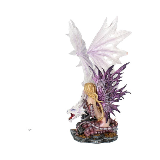 A fairy with purple wings and long blonde hair sits gracefully on a white dragon's back. The dragon's wings are spread, and they rest on a rocky base.