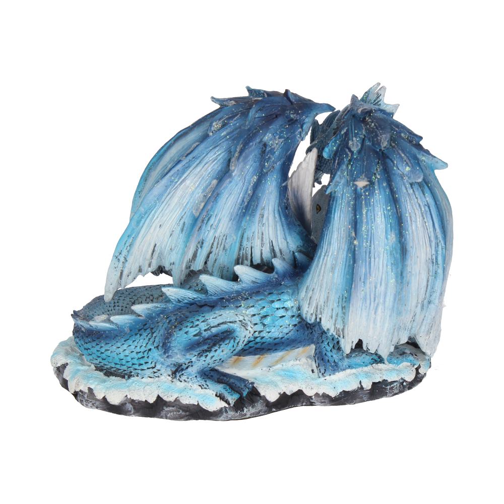 A blue dragon figurine rests on a textured base, its wings folded back. The dragon's scales are detailed, and the piece is set against a plain, white background.