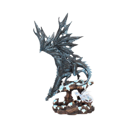 A detailed, winged dragon sculpture perches on a rocky base, covered with scattered snow. The dragon's wings are expansive and textured, appearing majestic in its frozen landscape.