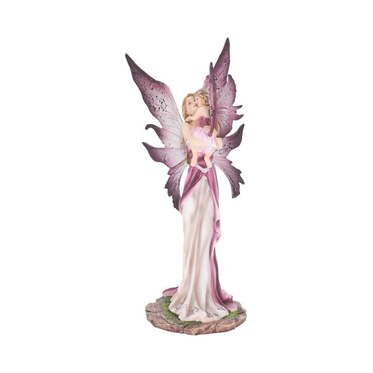 A figurine depicts a fairy with large purple wings, holding a child. The fairy is dressed in a flowing white and pink gown. The base resembles a stone path.