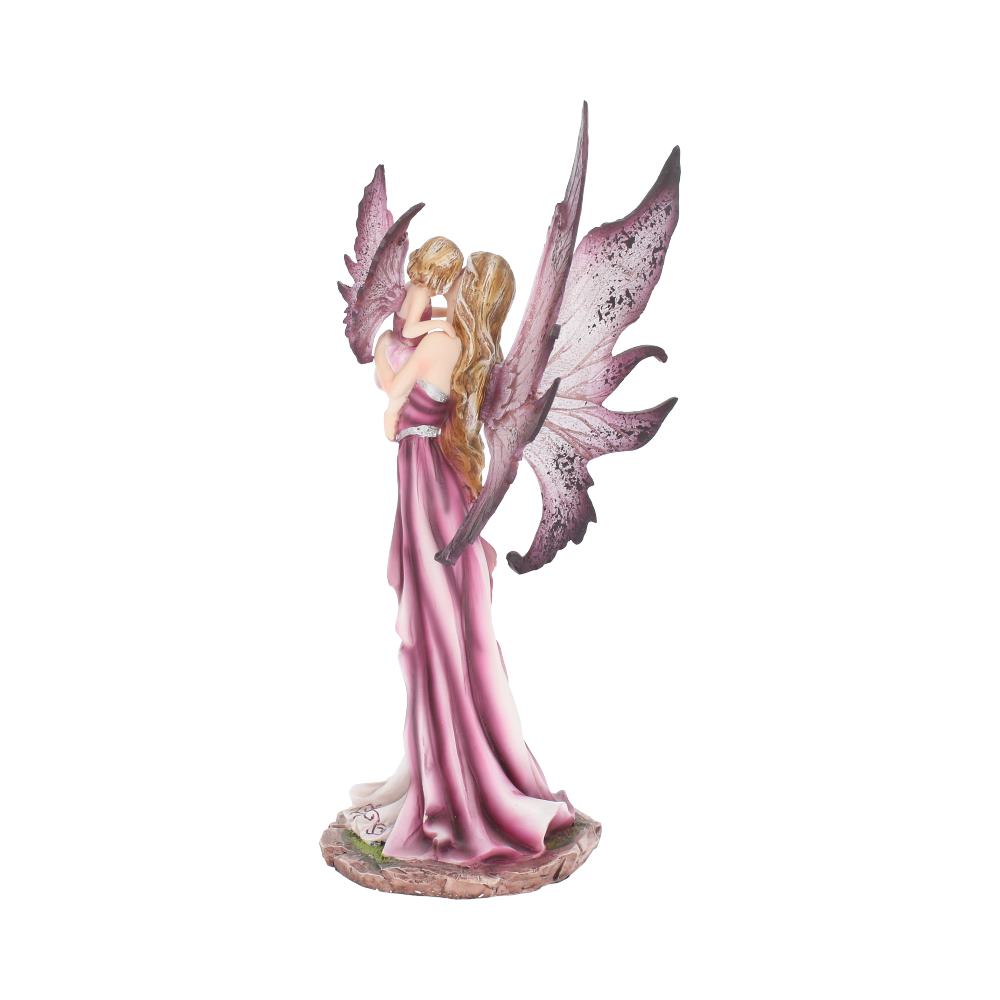 A fairy figurine with pink wings holds a small child, both in flowing pink garments, standing on a textured base, against a plain white background.