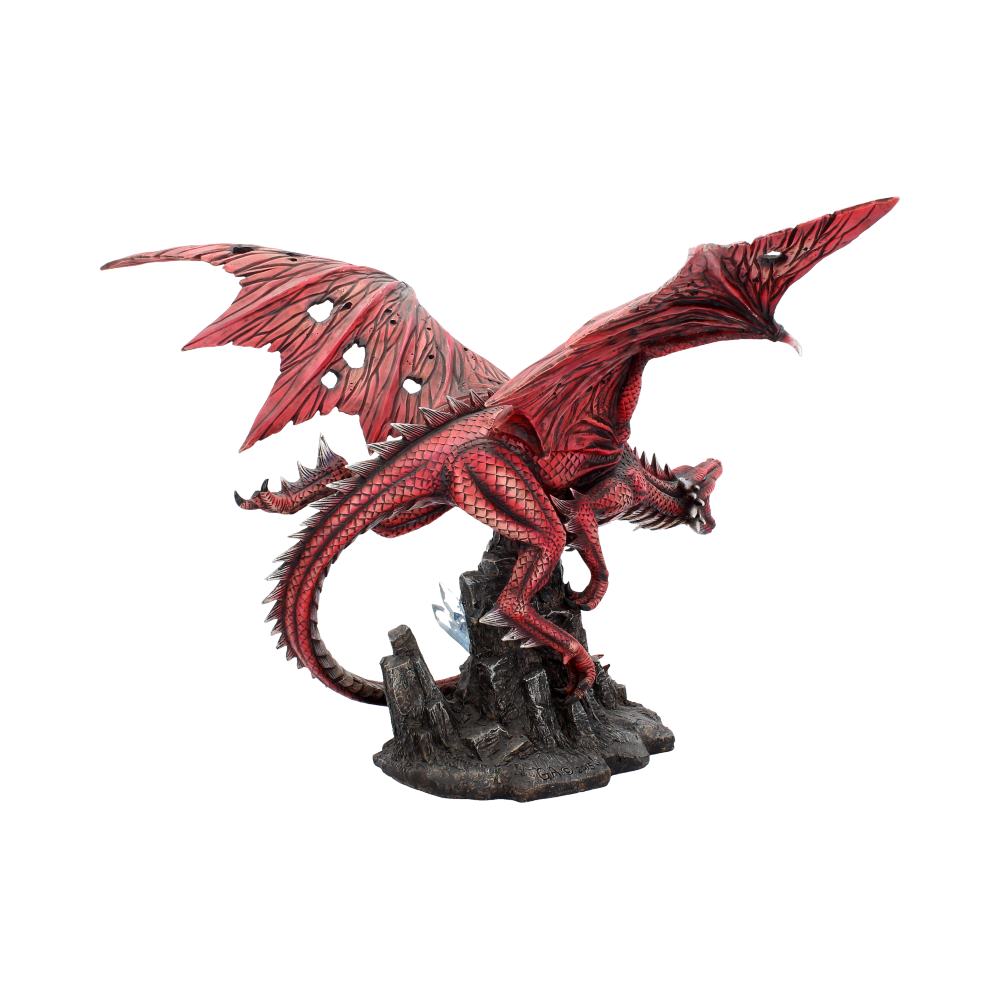 A red dragon sculpture with tattered wings stands fiercely atop a rocky base, displaying detailed scales and an aggressive posture, suggesting movement or a powerful presence.