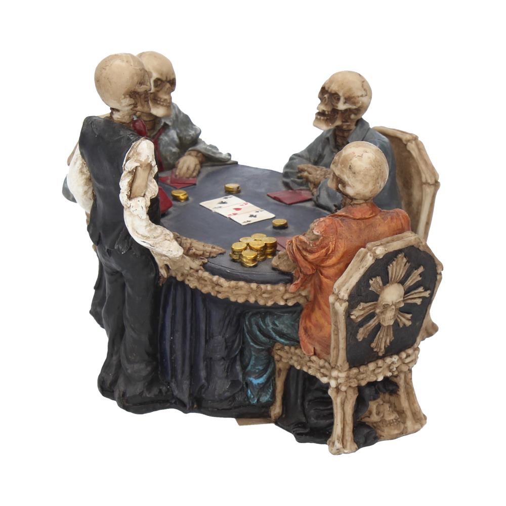 Four skeleton figurines are playing poker around a dark blue table with gold coins and cards. They sit in bone-themed chairs, with one skeleton wearing a black suit.