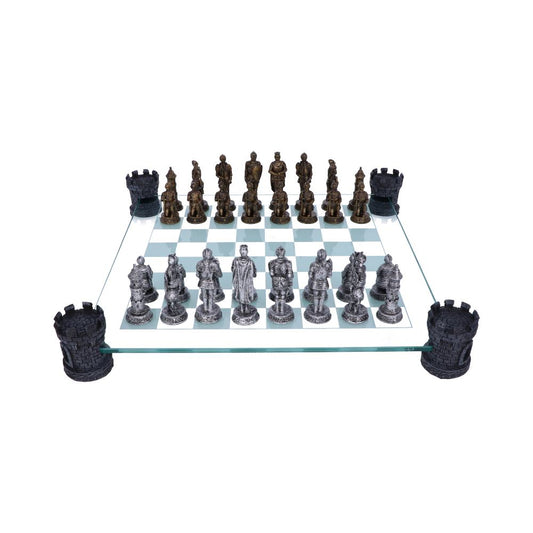 A glass chessboard, holding intricately designed chess pieces in silver and bronze, sits on a white background, supported by four castle-shaped corner pieces.