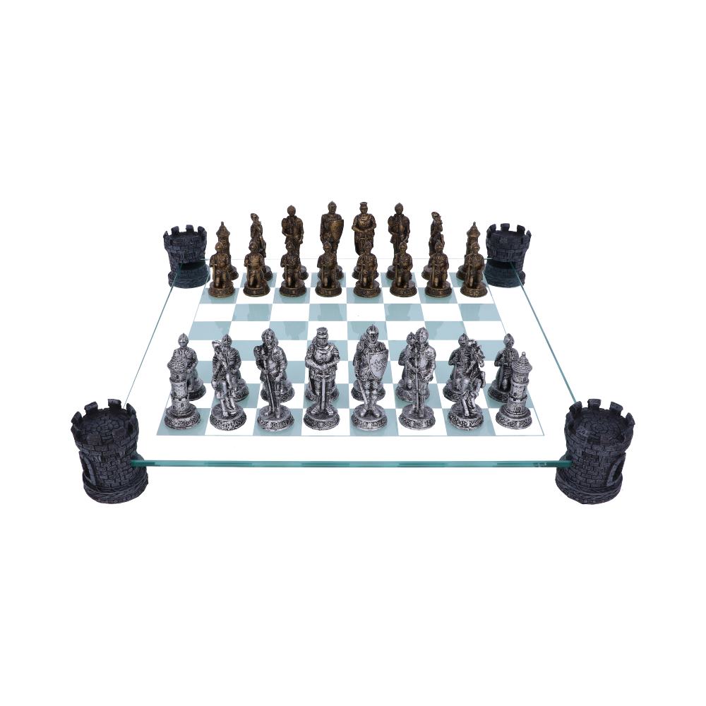 A chess set, arranged for the start of a game, sits on a glass board. The pieces are sculpted as medieval knights, and the board rests on castle-shaped supports.