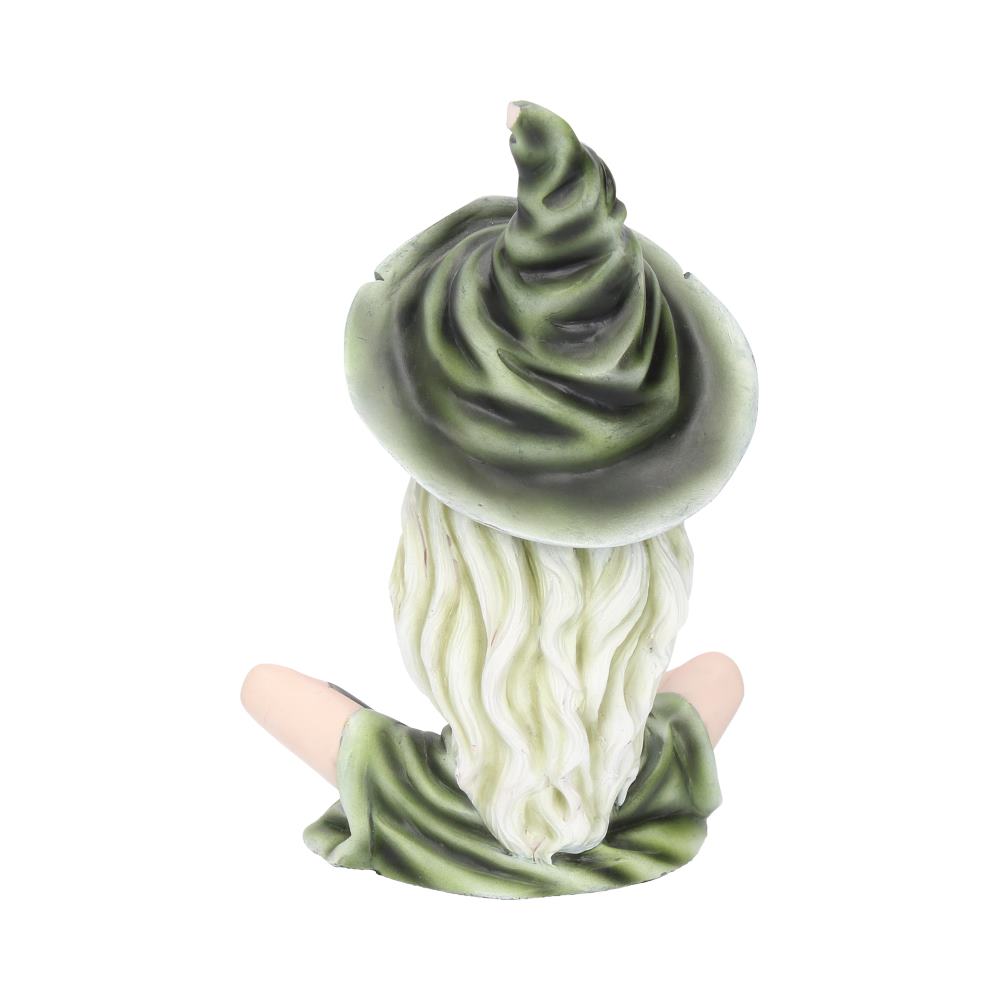 A figurine of a seated witch with long white hair, wearing a pointed, dark green hat and robe, viewed from behind against a plain, white background.