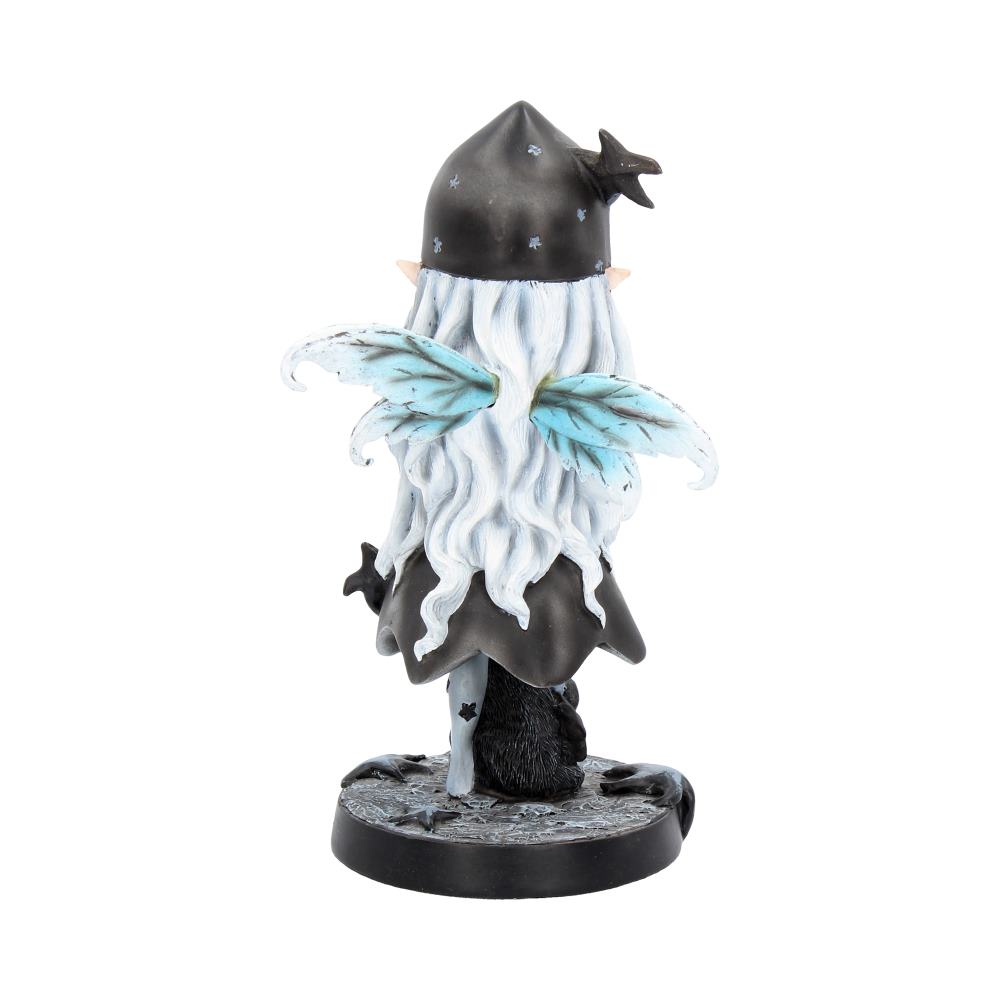 A small figurine with a black star-patterned hat and cape, light blue wings, and long white hair stands on a decorative base. There's no visible text.