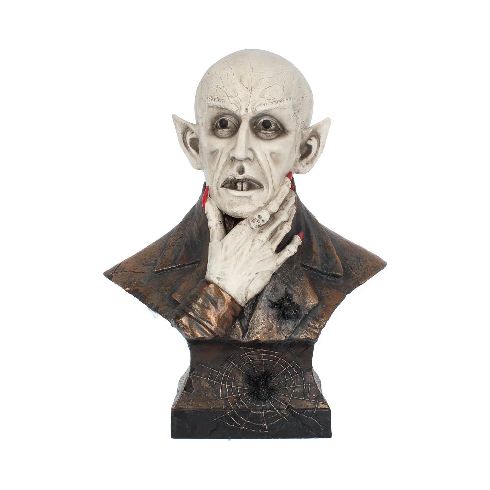A pale, bald vampire bust clutches its neck, wearing a dark suit and a skull ring. It stands on a base with a spiderweb design on a white background.