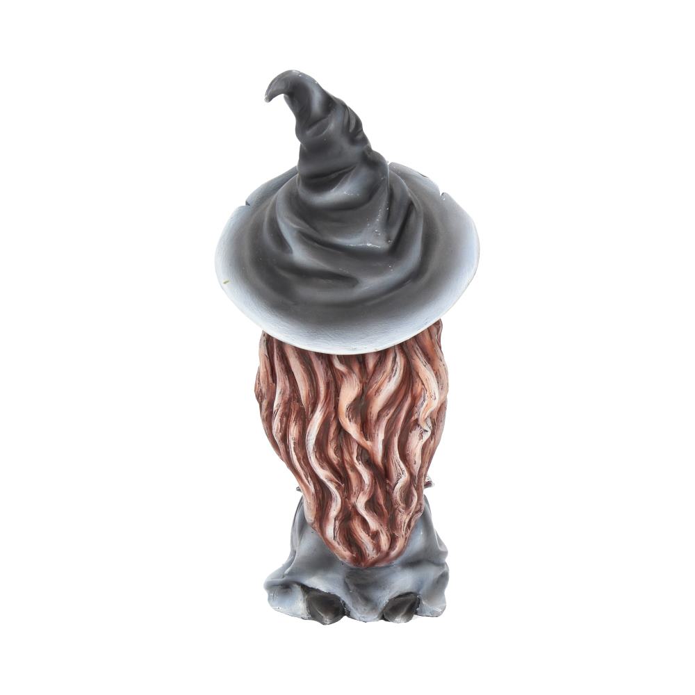 A small figurine appears with a tall, twisted hat covering its face, long wavy beard protruding, and standing on a surface, conveying a whimsical, mystical character.