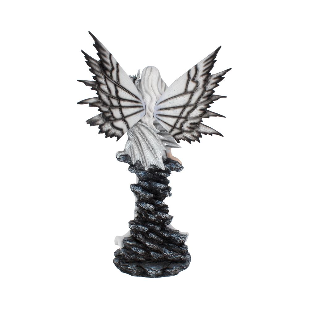 A figurine with white and black butterfly wings is perched atop a spiraling, textured black pedestal, set against a plain white background.