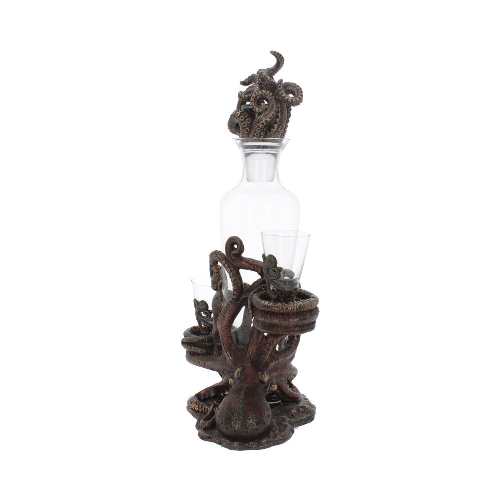 A glass decanter sits atop a bronze octopus figurine that is also holding 2 glasses. The decanter is sealed with another bronze octopus. The background is white.