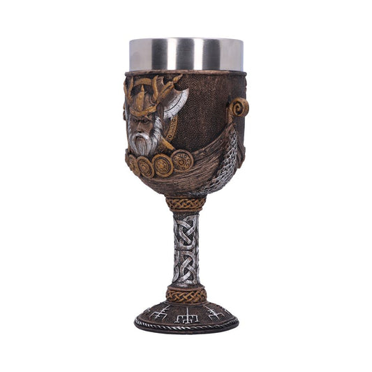 A goblet with a stainless steel interior is detailed with a viking theme. A face, boat, and symbols adorn the goblet, which rests on a white background.