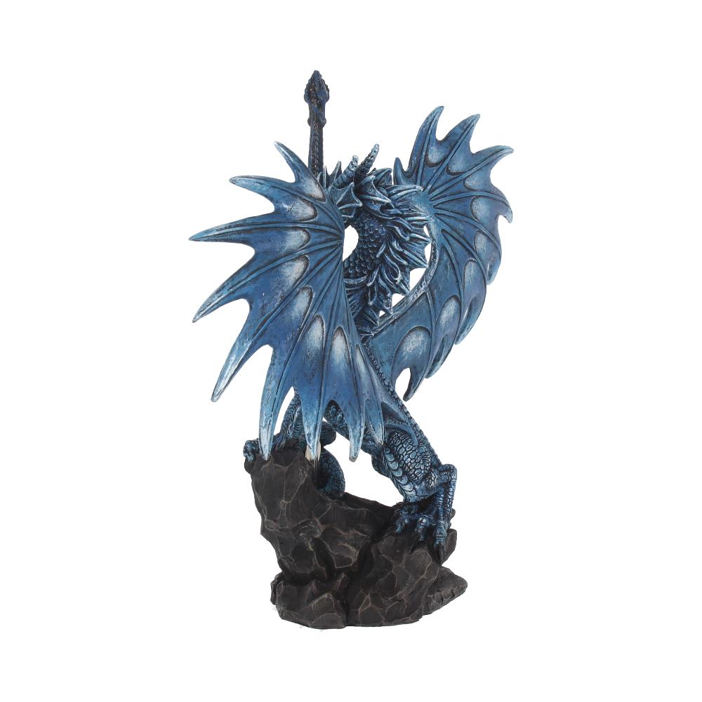 A blue dragon figurine rests on a dark rock, its wings spread, holding a sword upright; isolated on a white background.